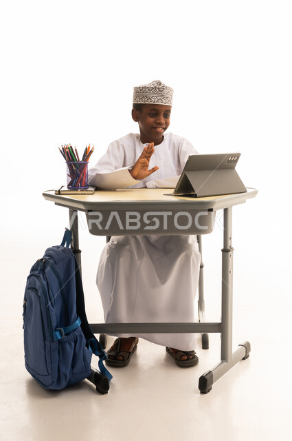 Omani Boy on Tablet Computer in Studio Setting