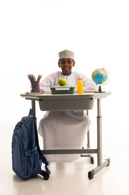 طالب عماني على مقعد الدراسة مع وجبة غداء صحية