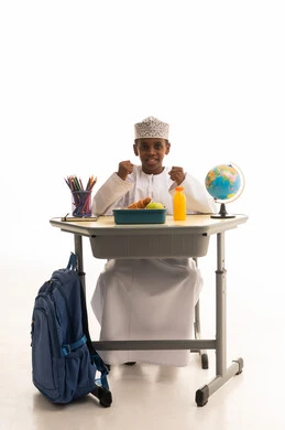 Omani Student at School Desk with Globe
