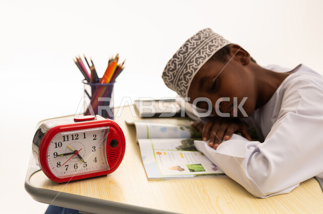 Omani Boy Sleeping on Desk While Studying