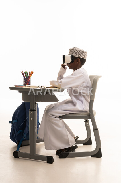 Omani Boy Using VR Headset at School Desk