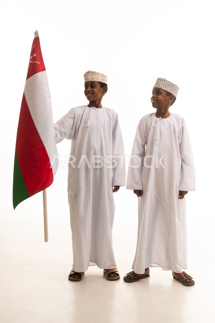 Omani Boys Holding National Flag in Traditional Dress