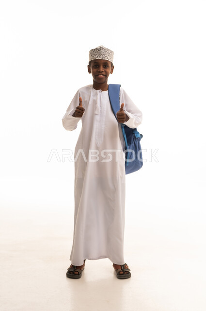 Omani Boy in Traditional Dress with School Bag