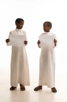 Saudi Boys in Traditional Thobes Holding Blank Signs