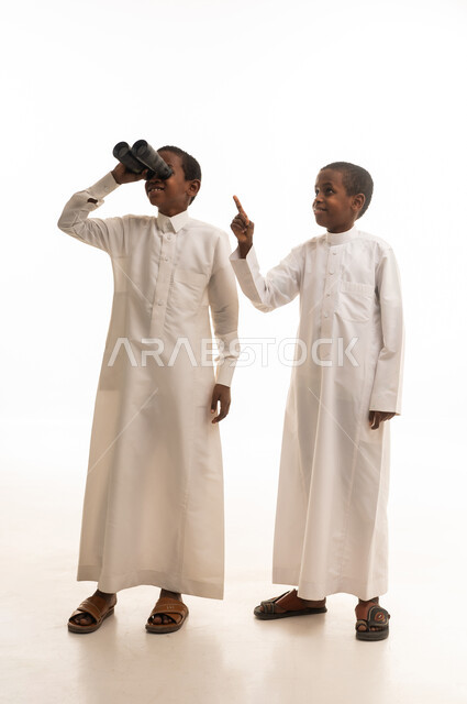 Saudi Boys in Traditional Thobes with Binoculars