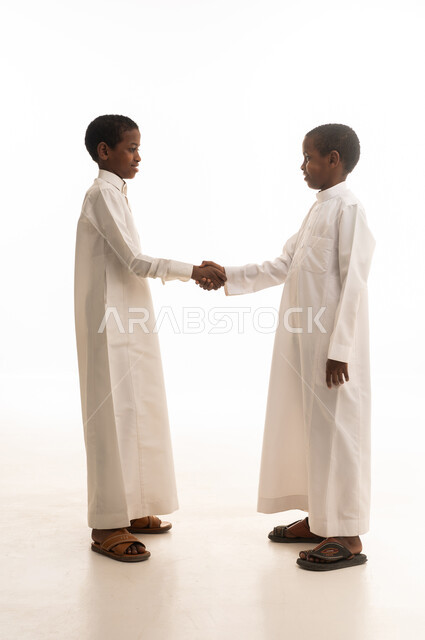 African Boys in Traditional Thobe Shaking Hands