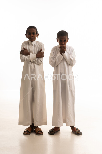 Saudi Boys in White Thobes Shivering from Cold