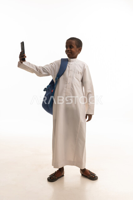 Saudi Boy in Thobe Taking Selfie with Smartphone