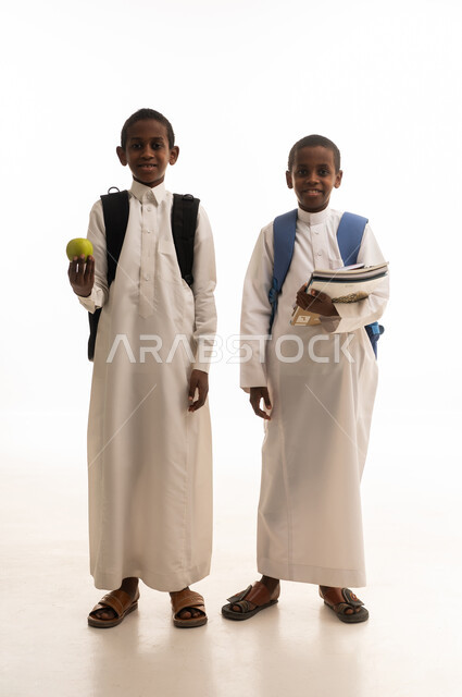 Saudi School Boys in Traditional Thobes with Books