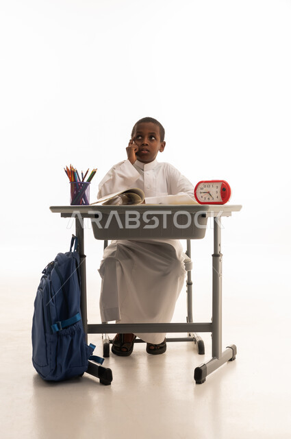 Saudi Student at School Desk on White Background