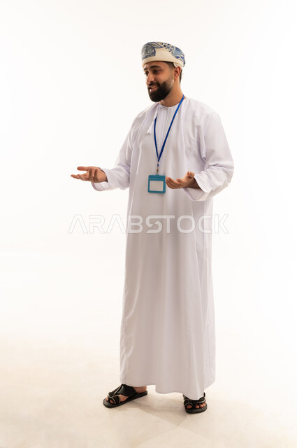 Omani Man in Traditional Dress with ID Badge Speaking