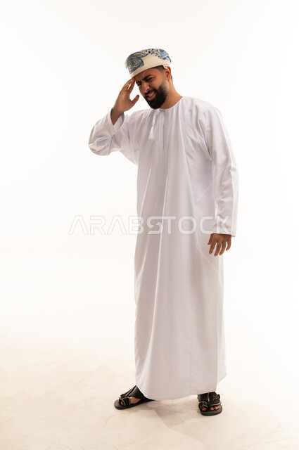 Omani Man with Headache in Traditional White Dishdasha