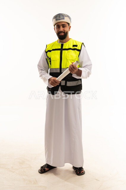 Omani Engineer in Safety Vest Holding Blueprints