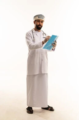 Omani Doctor Writing in Medical Folder in Studio