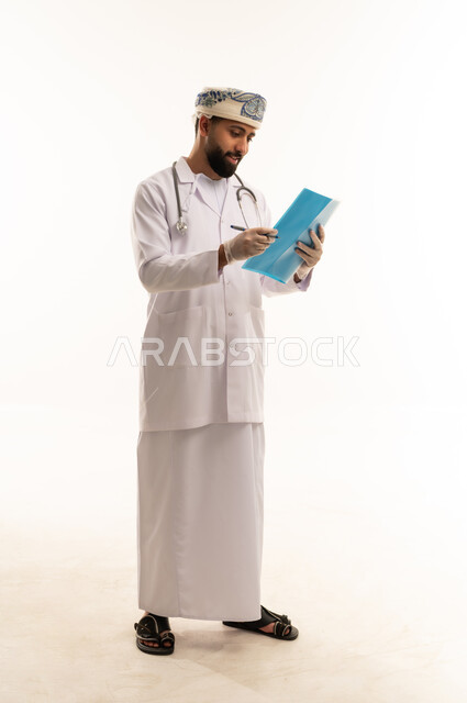 Omani Male Doctor Writing in Medical File
