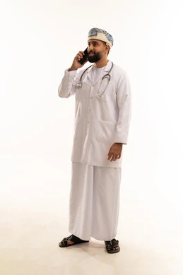 Omani Doctor in White Lab Coat Using Mobile Phone