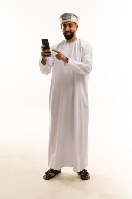 Omani Man in Traditional Dress Using Smartphone