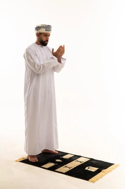 Omani Man Praying in Traditional White Dishdasha
