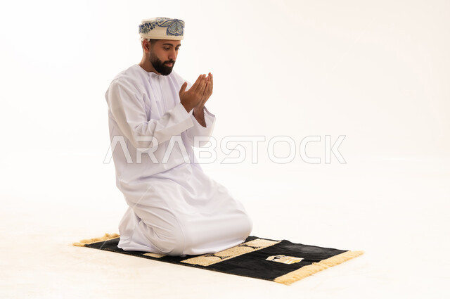 Omani Man Praying and Supplicating on White Background