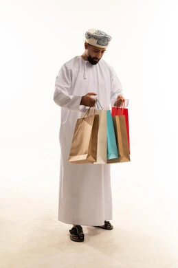 Omani Man in Traditional Dress with Shopping Bags