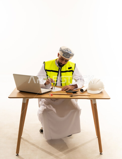 Omani Engineer Working at Desk in White Studio