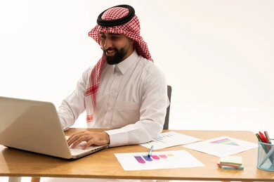 Saudi Businessman Working on Laptop at Office Desk
