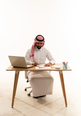 Saudi Businessman at Office Desk Reviewing Documents