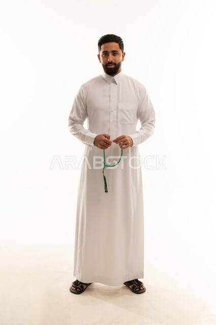 Saudi Man in White Thobe Holding Prayer Beads