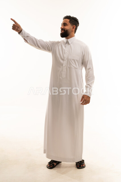 Saudi Man in White Thobe Pointing in Studio