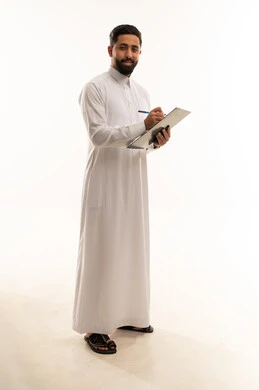 Saudi Man in Thobe Writing on Clipboard in Studio