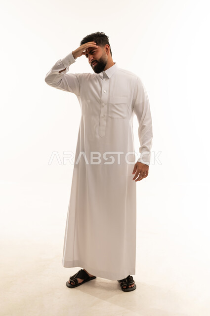 Saudi Man in Thobe Expressing Stress and Headache