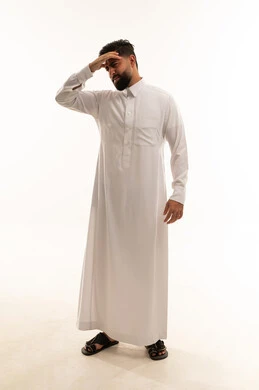 Saudi Man in Thobe Expressing Stress and Headache