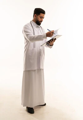 Saudi Doctor Writing on Medical Clipboard in Lab Coat