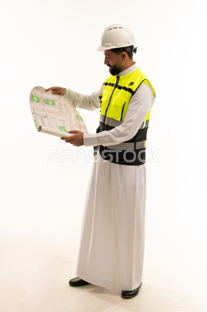 Saudi Engineer in Safety Gear Holding Blueprint
