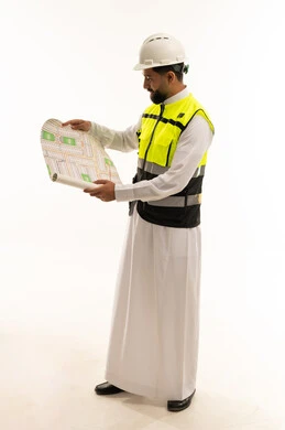 Saudi Engineer in Safety Gear Holding Blueprint