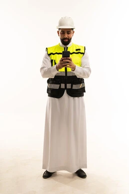 Saudi Engineer Using Smartphone in Safety Gear