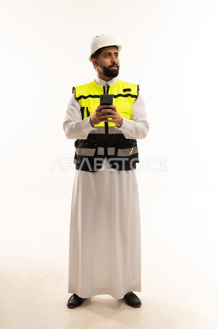 Saudi Engineer in Safety Vest Holding Smartphone