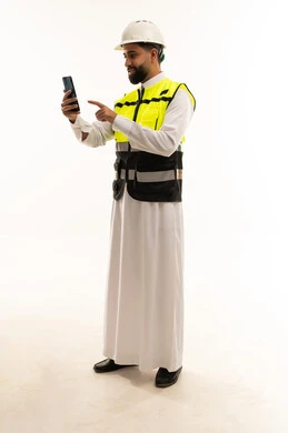 Saudi Civil Engineer in Safety Vest Using Smartphone