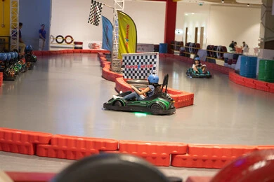 أطفال يتسابقون في سيارات الكارتينج بمركز ترفيهي