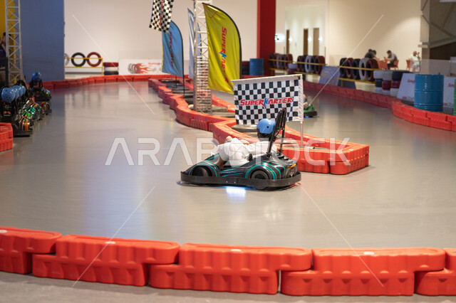 Saudi Boy Driving Go-Kart on Indoor Racing Track