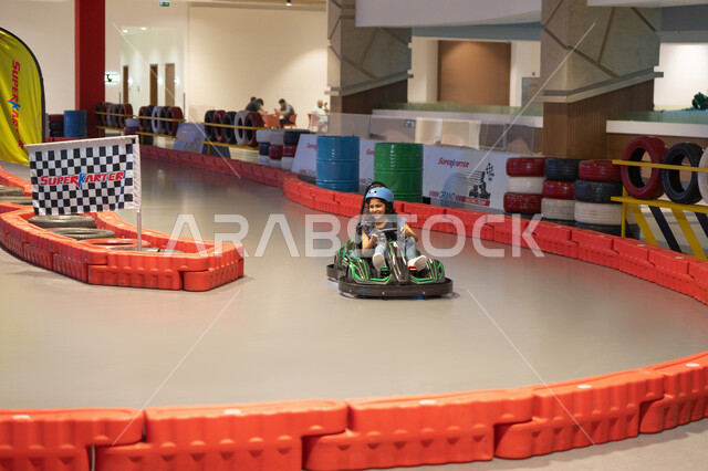 Arab Girl Driving Go-Kart on Indoor Racing Track