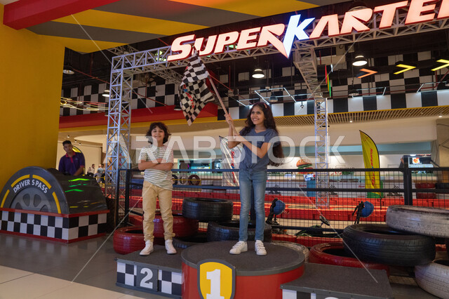 Arab Children on Go-Karting Podium with Flag