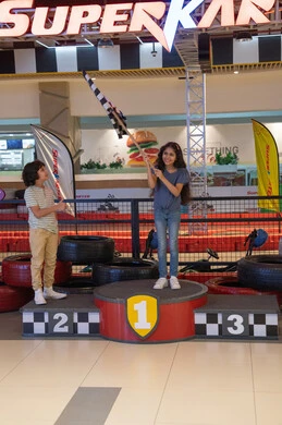 Arab Children on Racing Podium in Indoor Arena