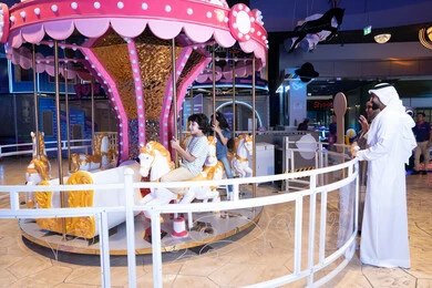 رجل إماراتي مع أطفاله في مدينة ملاهي داخلية