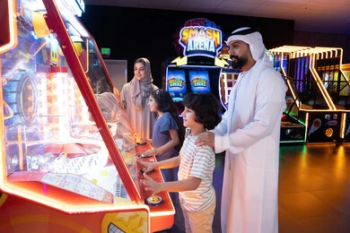 Emirati Family Playing Arcade Games Indoor