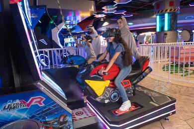 Emirati Family Playing Virtual Reality Motorcycle Game