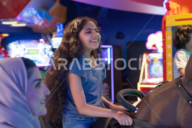 Saudi Girl Smiling at Indoor Amusement Park Arcade
