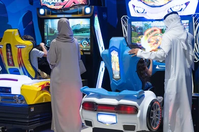 عائلة عربية تلعب ألعاب سيارات إلكترونية في ملهى