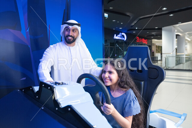 Emirati Man and Girl Using Car Racing Simulator