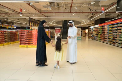 Emirati Family Shopping in Supermarket Aisle